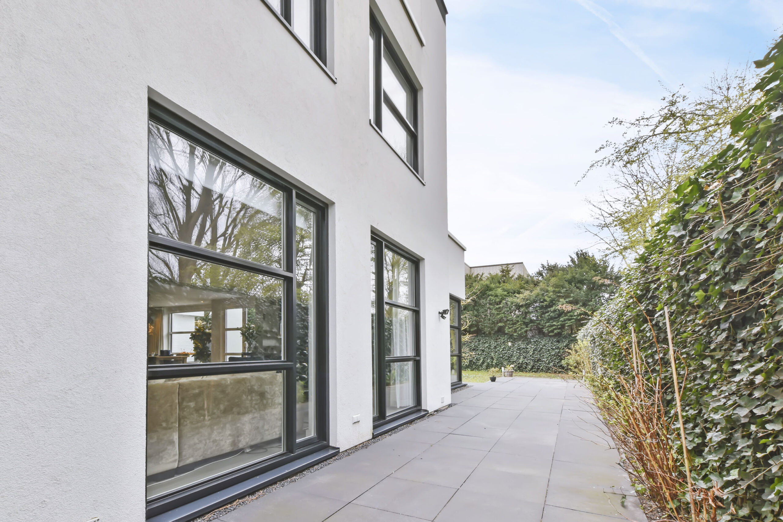 the courtyard of the house is in a minimalist style with large windows